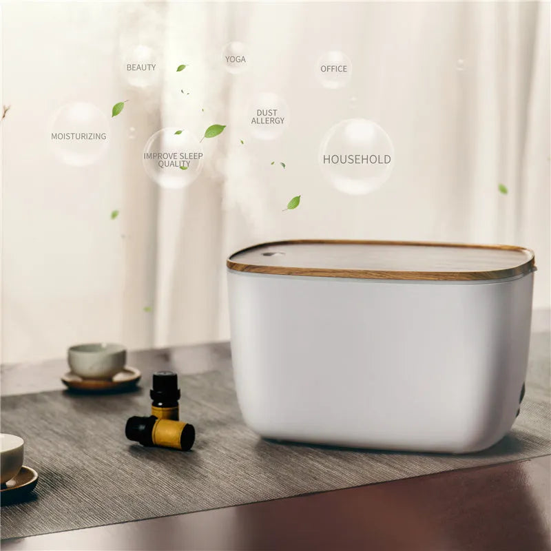 GX-22K white aromatherapy humidifier with night light and water tank on a wooden table.