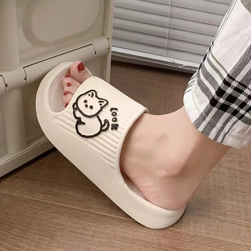 Green EVA platform flip flop slippers with a raised cat design on the upper.