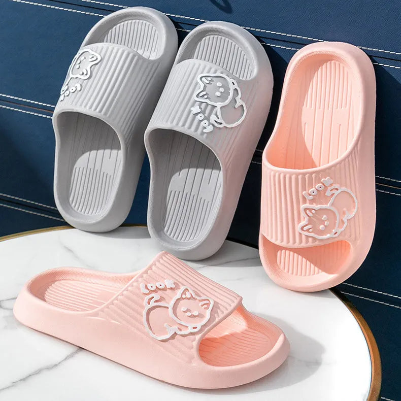Green EVA platform flip flop slippers with a raised cat design on the upper.
