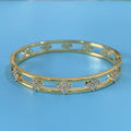 Gold or silver adjustable hollow bracelet with a four-leaf clover charm inlaid with a zircon stone.