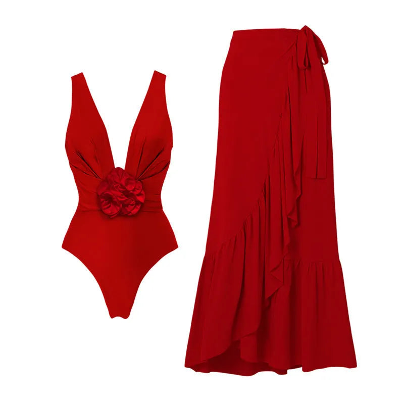 Red floral print women's one-piece swimsuit with V-neck halter and detachable long skirt on a model.