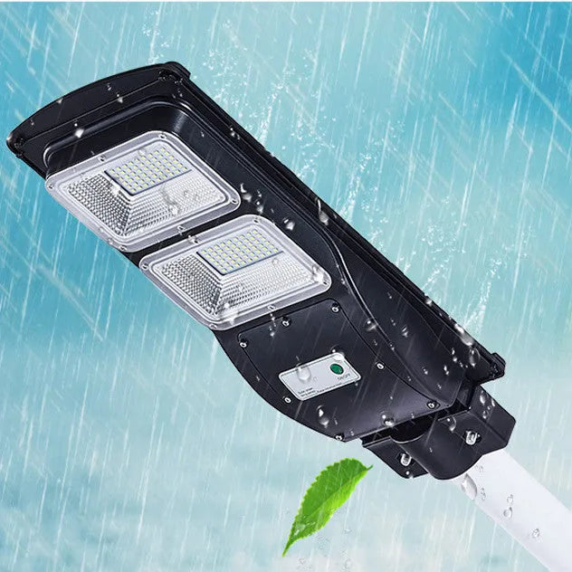 Integrated solar-powered street light with LED panel and remote control for outdoor use.