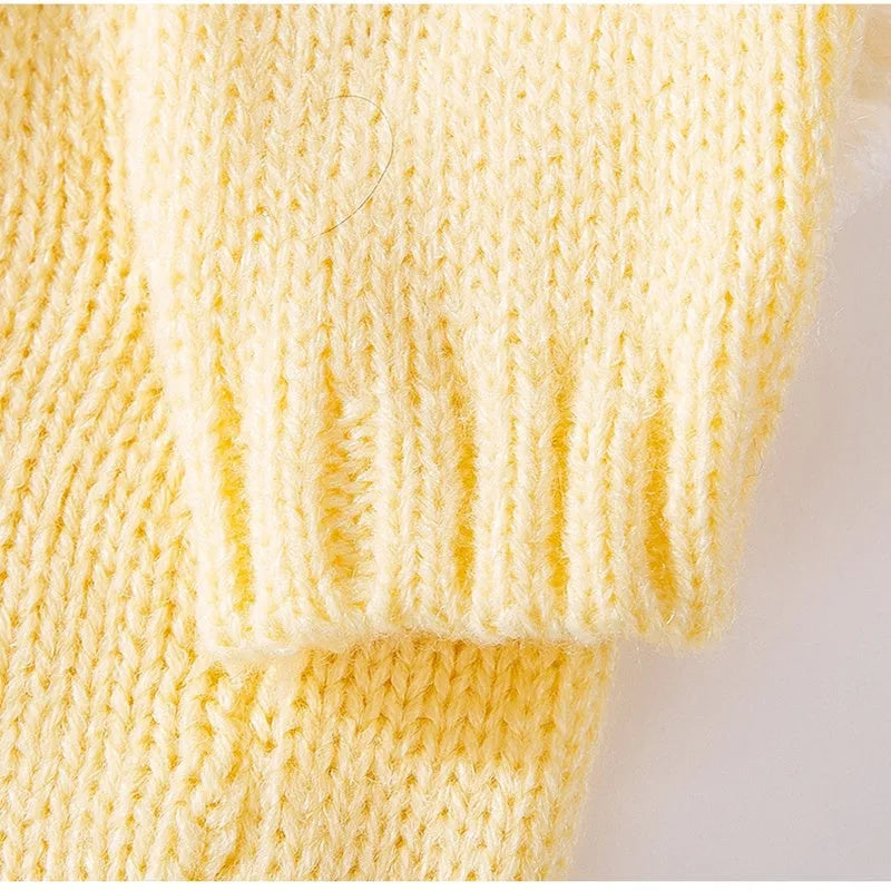 Yellow knitted dog sweater with star pattern and turtleneck on small breed puppy