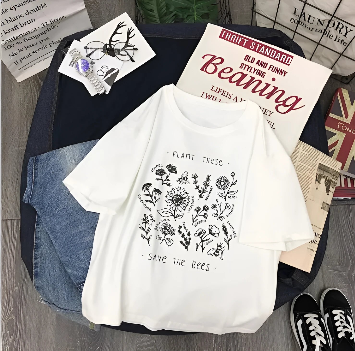 Woman wearing a white cotton Save The Bees t-shirt with a cartoon natural scenery print