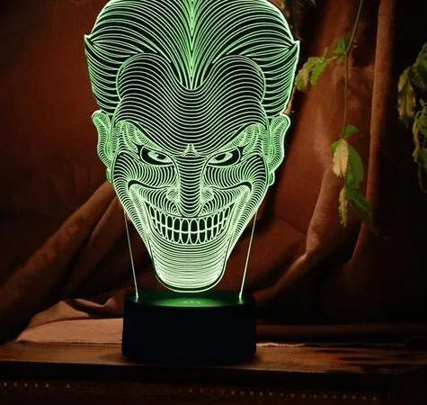 USB-powered 3D acrylic LED table lamp showing seven colour options on a desk