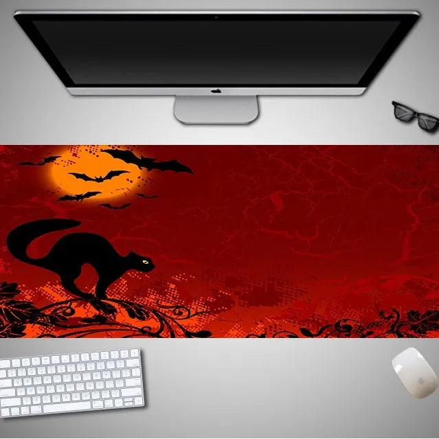 Large Halloween-themed computer mouse pad with graphic design on a desk