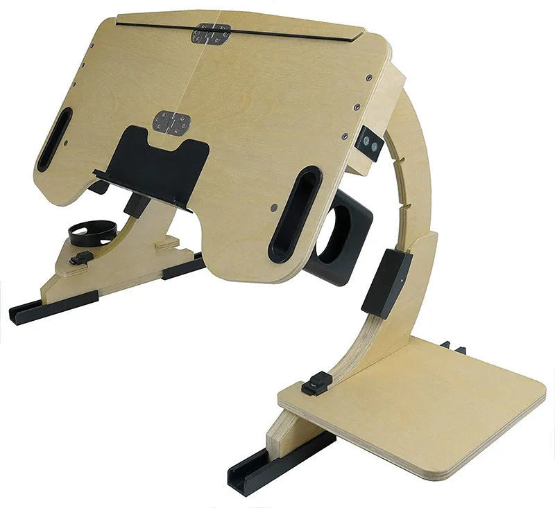 Wooden folding computer table on bed showing adjustable angle mechanism in white maple finish