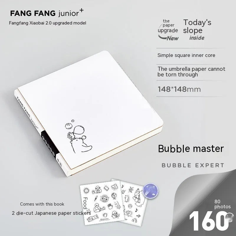 Small white square notebook with checkered pages and decorative sticker sheets