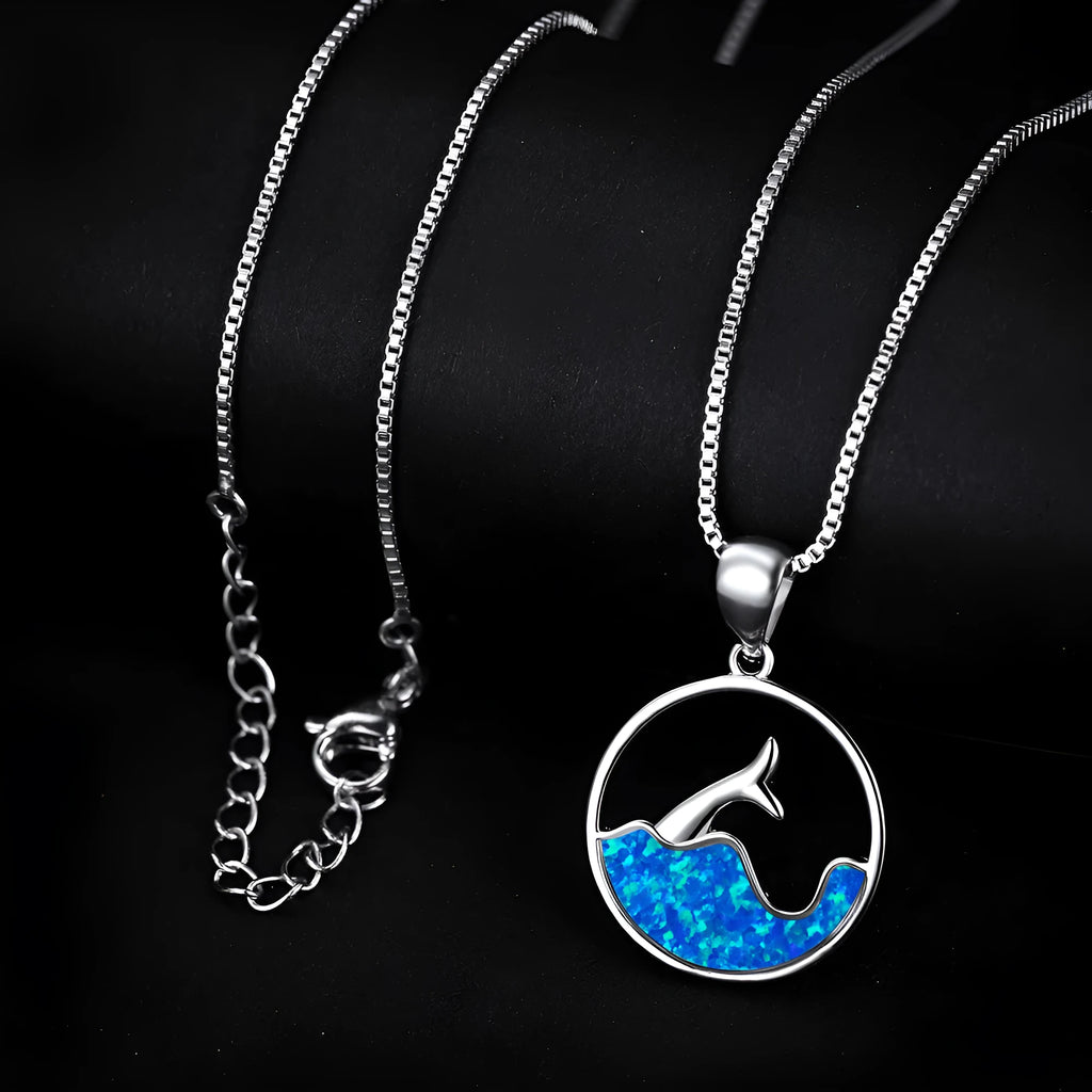 White gold electroplated necklace with a round geometric fishtail pendant in blue opal colour.