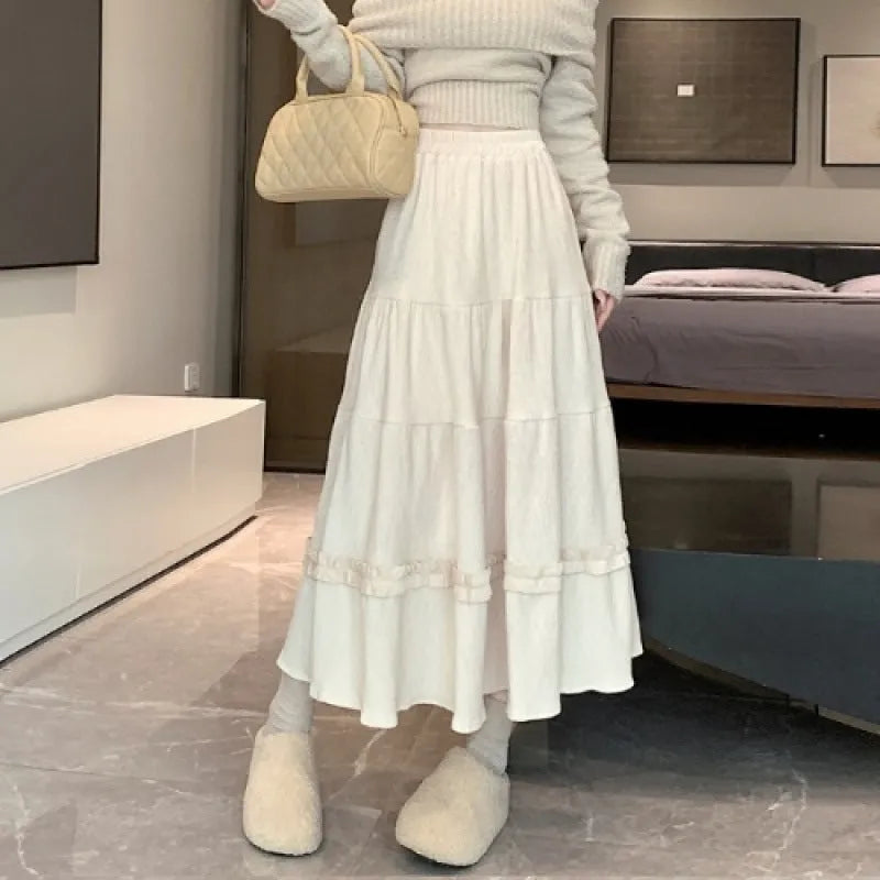 Corduroy A-line midi skirt with elastic waistband in beige, black or brown colours showing Korean style slimming silhouette