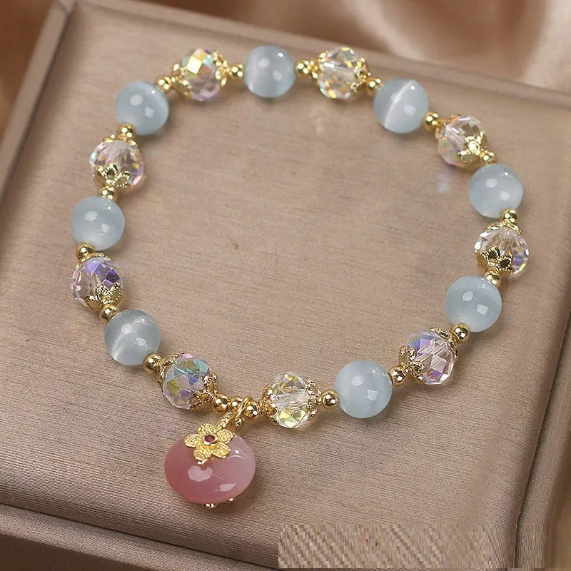 Chinese style sky blue opal peace buckle pendant bracelet for women on a flat surface