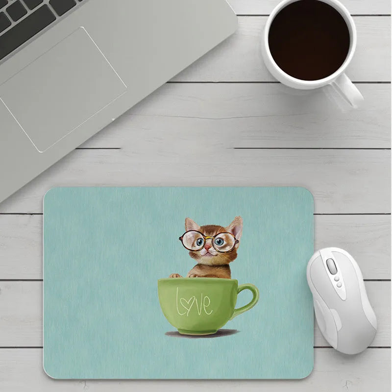Custom cartoon thickening mouse pad on a desk, showing a colourful design with black stitched edge.