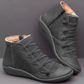 Women's black casual ankle booties with a flat wedge heel and round toe, made from PU with a rubber sole.
