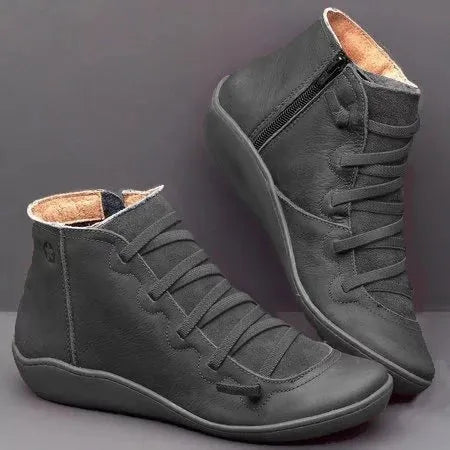 Women's black casual ankle booties with a flat wedge heel and round toe, made from PU with a rubber sole.