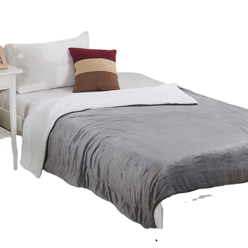 Grey and white USB electric heating blanket with intelligent temperature control on a sofa.