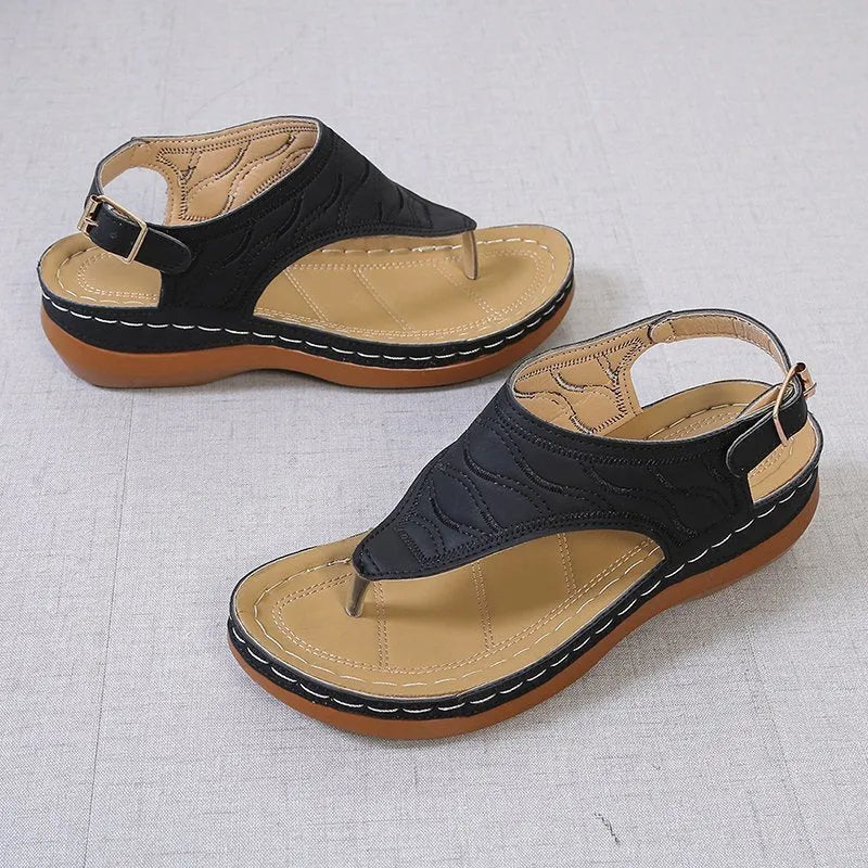 Women's casual wedge heel flip flop sandals with an adjustable buckle strap in black.