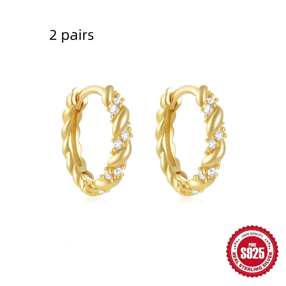 Sterling silver geometric stud earrings with small round design elements in gold or silver finish