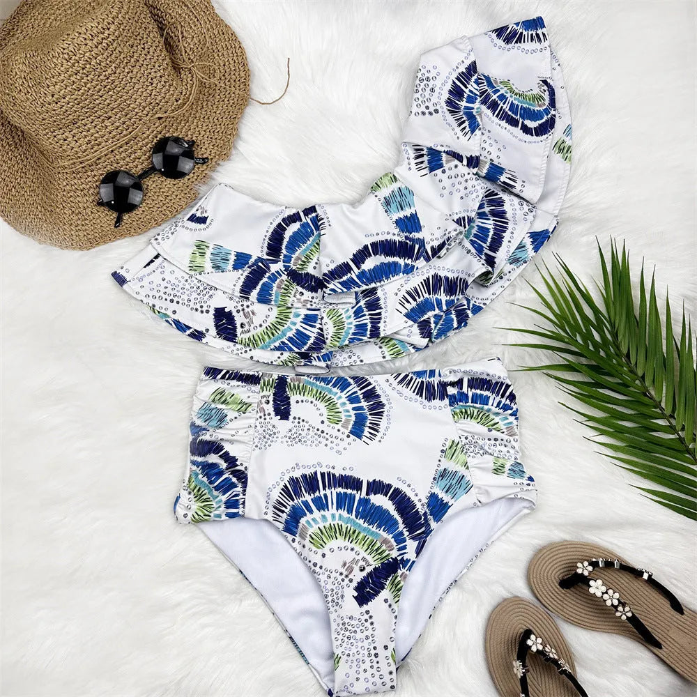 White women's one-shoulder swimsuit with large lotus leaf detail and side split.