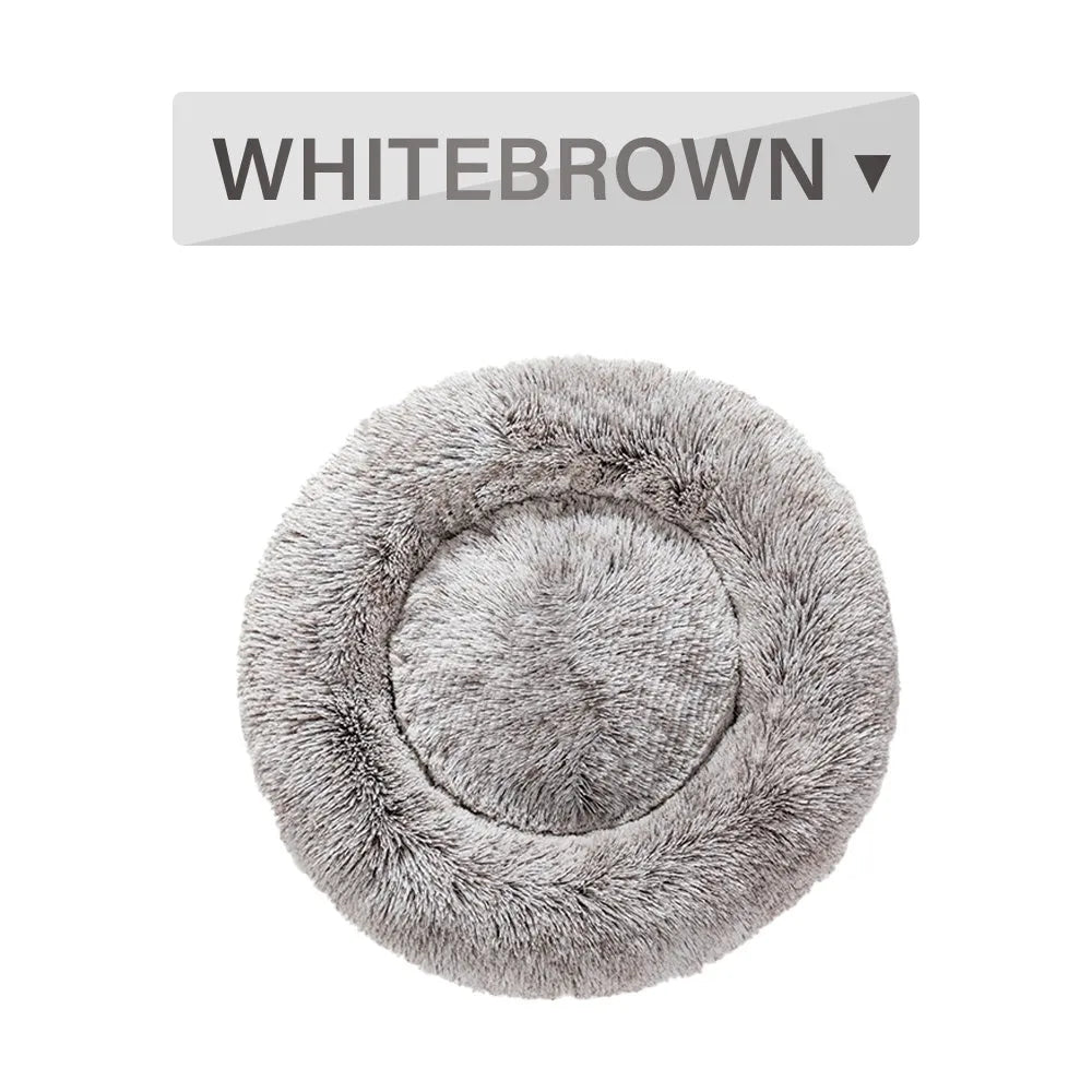 Fluffy donut-shaped pet bed in long plush fabric, shown in a light grey colour.