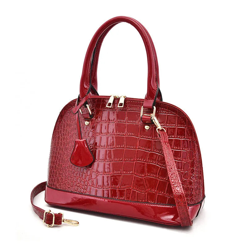 Shiny PU leather crossbody shoulder bag in structured shell shape design showing black colour option