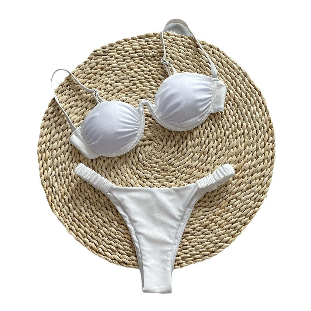 Women's black underwire bikini swimsuit set with split briefs on a neutral background.