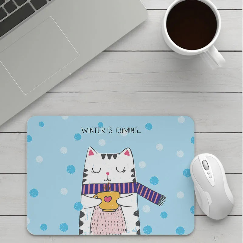 Custom cartoon thickening mouse pad on a desk, showing a colourful design with black stitched edge.
