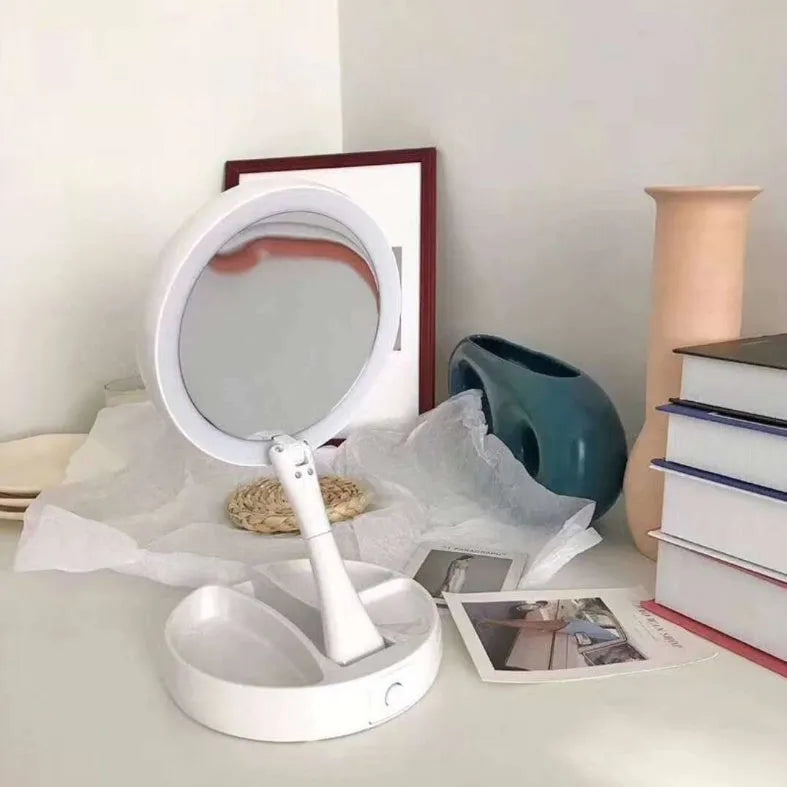 White foldable LED vanity mirror with open storage compartments and USB charging port.