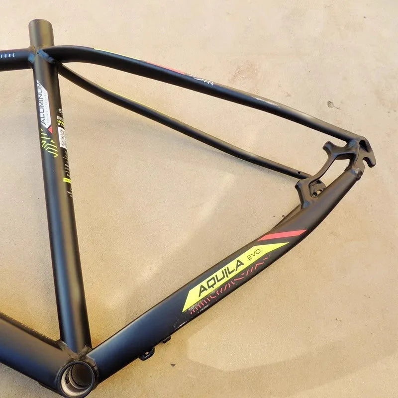 Black green 29-inch aluminium mountain bike frame with disc brake mount and internal cable routing ports.