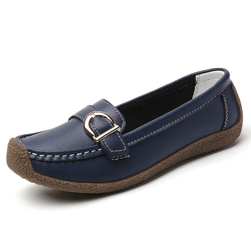 Women's beige loafers with round toe and flat heel on a light background
