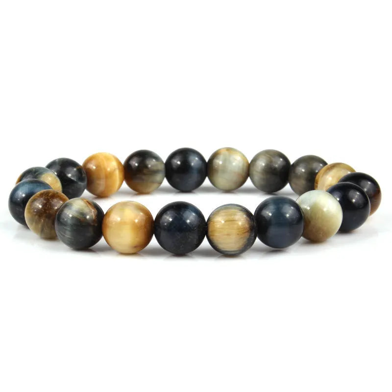 Tiger eye crystal stone bracelet showing round beads available in multiple colours and sizes on a wrist.