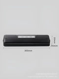 Small black automatic vacuum sealer machine on a kitchen countertop