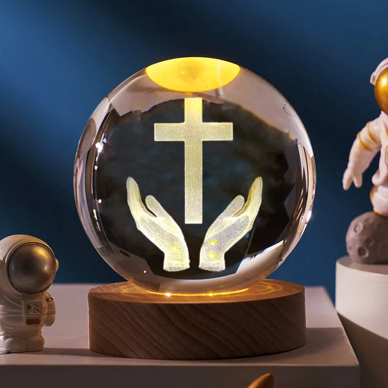 White crystal ball with cross and religious symbols on wooden LED base desk ornament