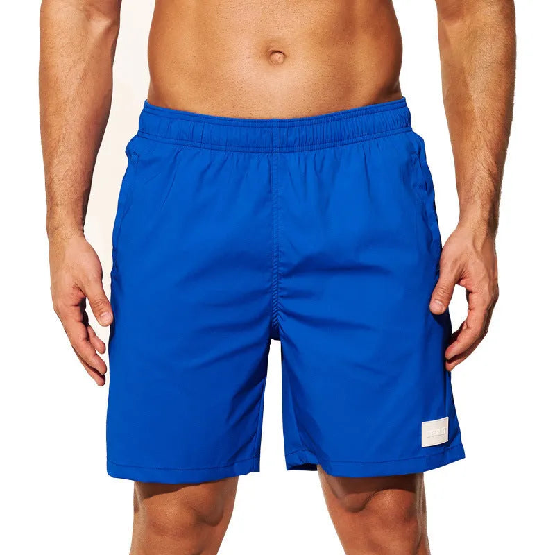 Men's quick-drying nylon sports shorts in green, shown with straight leg and elastic waist.
