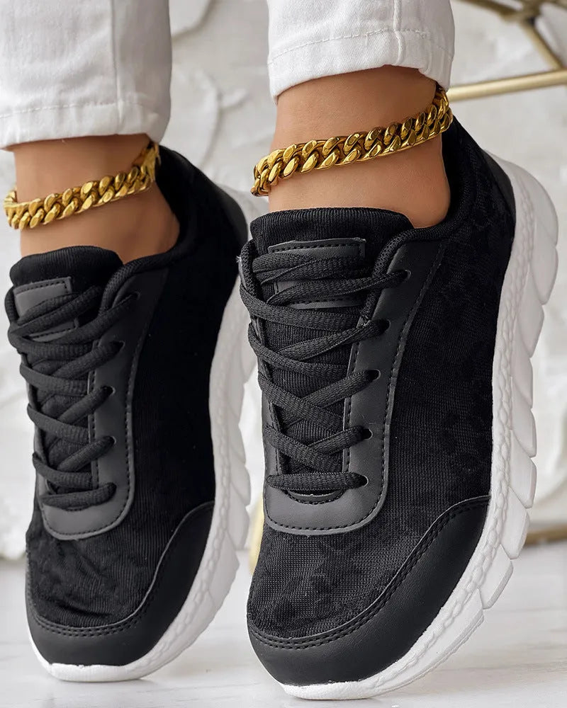 Women's white canvas running shoes with soft sole and flat heel on a plain background.