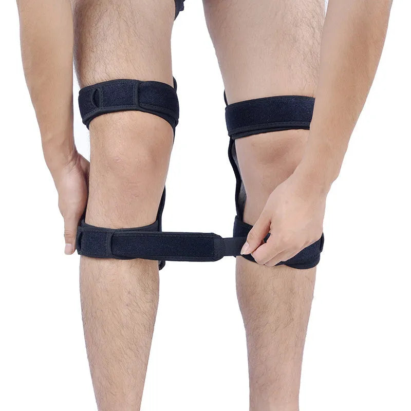 Adjustable black spring knee brace with straps and venting holes for sports support.