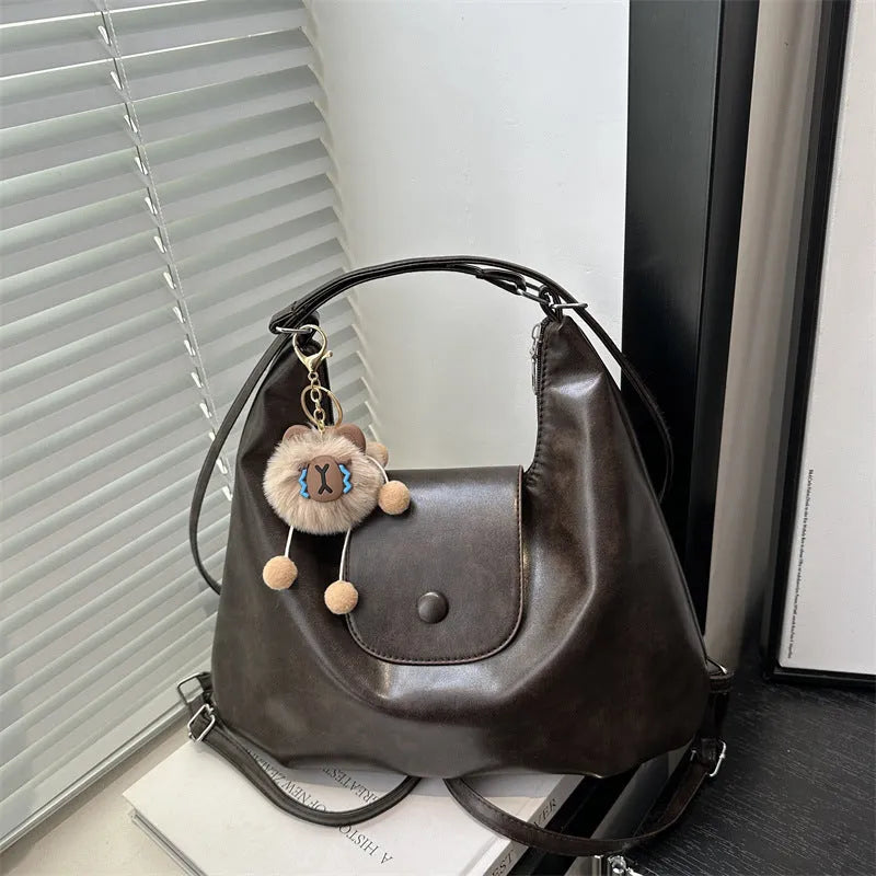 Women's PU leather commuter shoulder bag in horizontal square shape with single strap and optional pendant