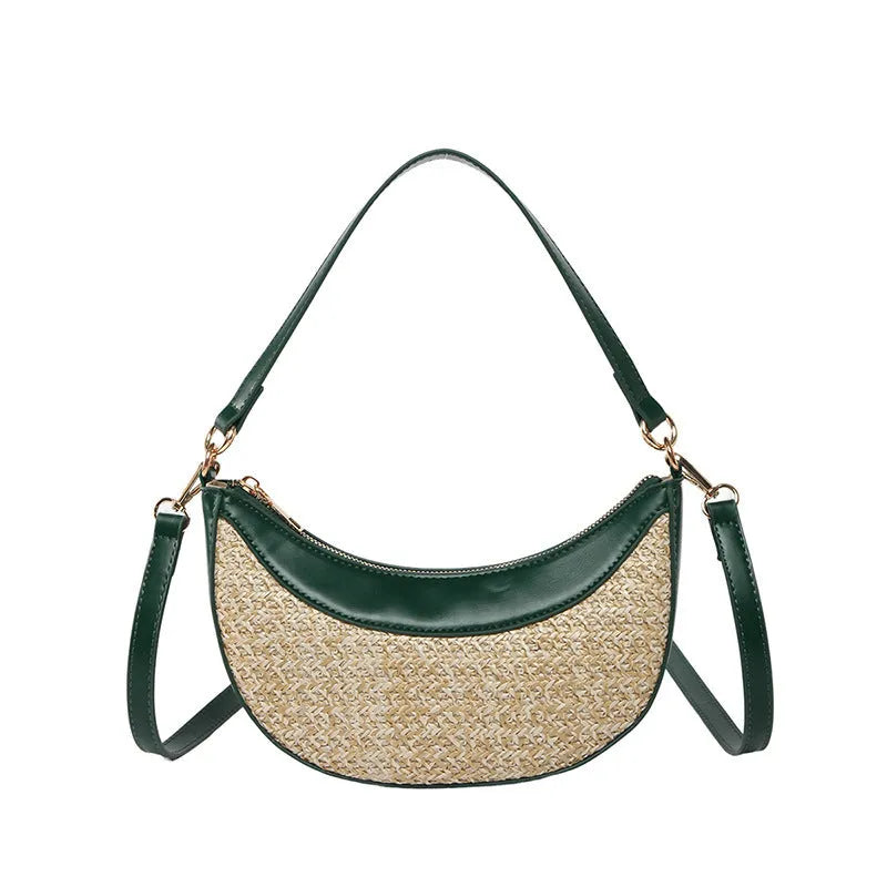 Hard woven straw dumpling-shaped crossbody bag in green with contrast stitching and a single shoulder strap.