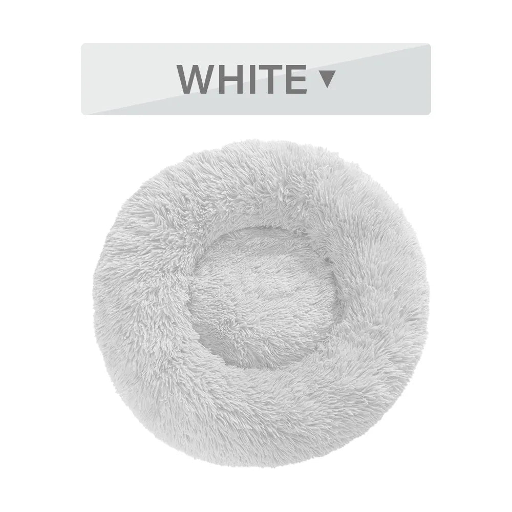 Fluffy donut-shaped pet bed in long plush fabric, shown in a light grey colour.