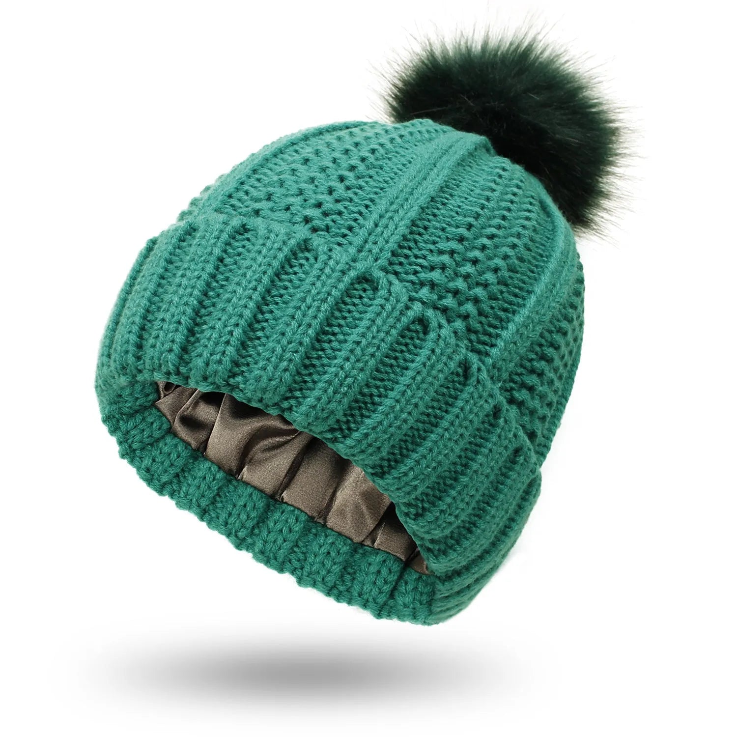 Woman wearing a light grey wool beanie with a faux fur pom pom and satin lining.