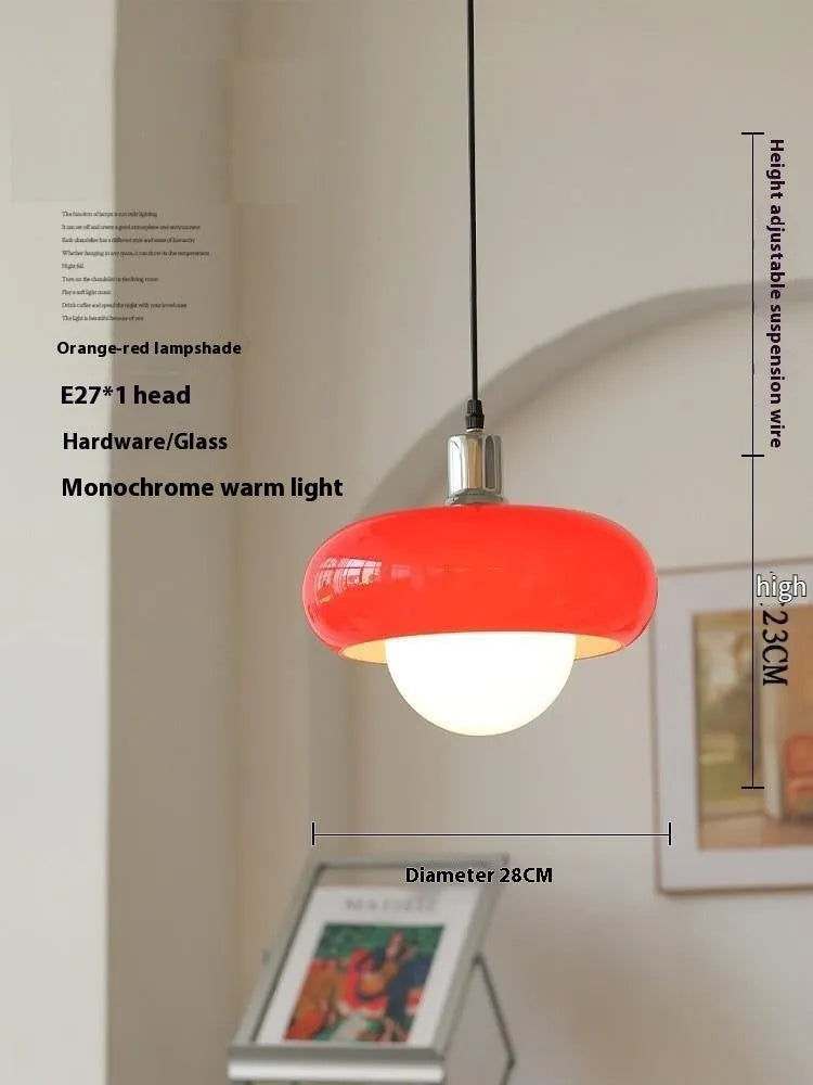 Three-headed Bauhaus pendant light with milky white glass egg tart shades hanging from a ceiling.