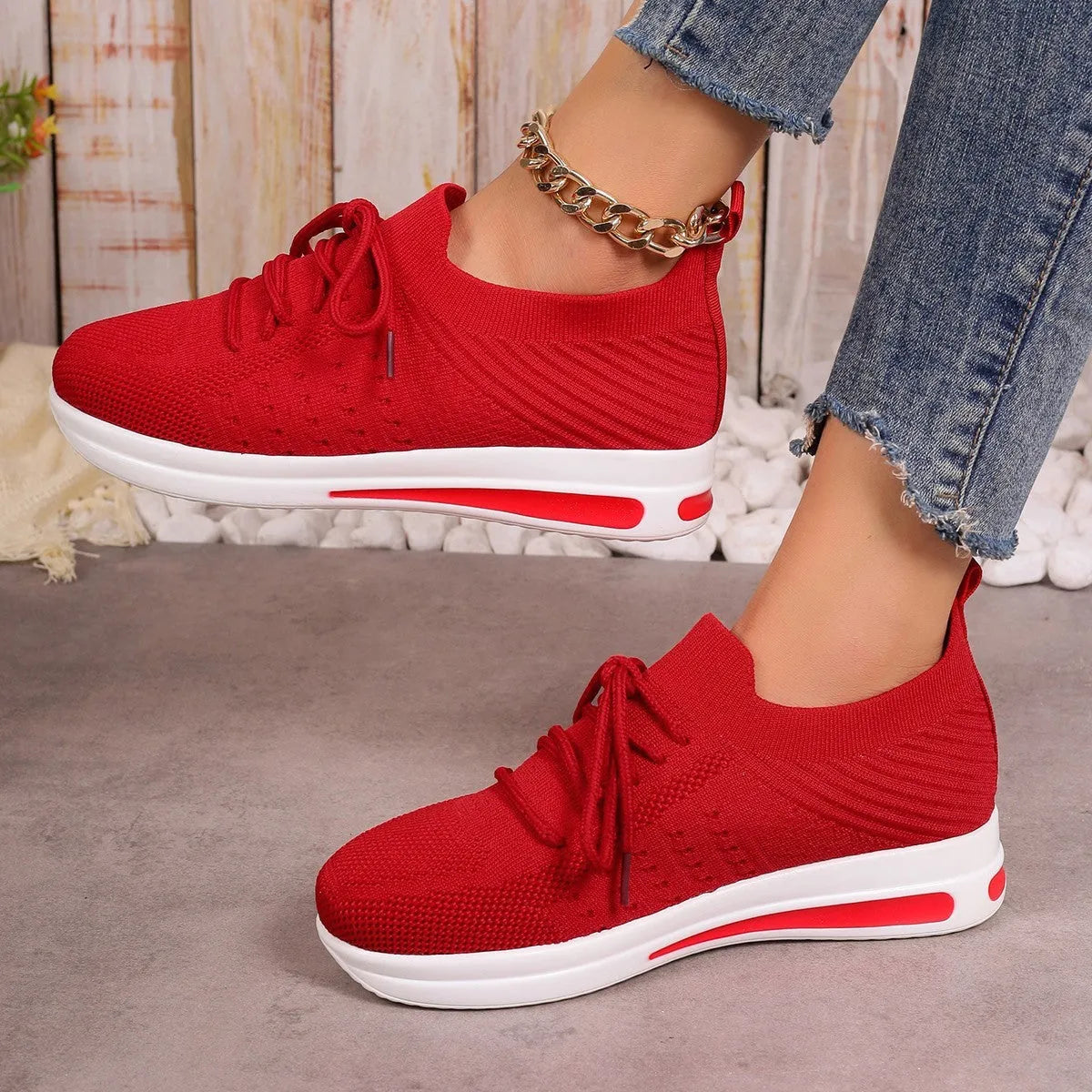 Women's black fly-knit casual sneakers with lace-up front and low-top design on a white background