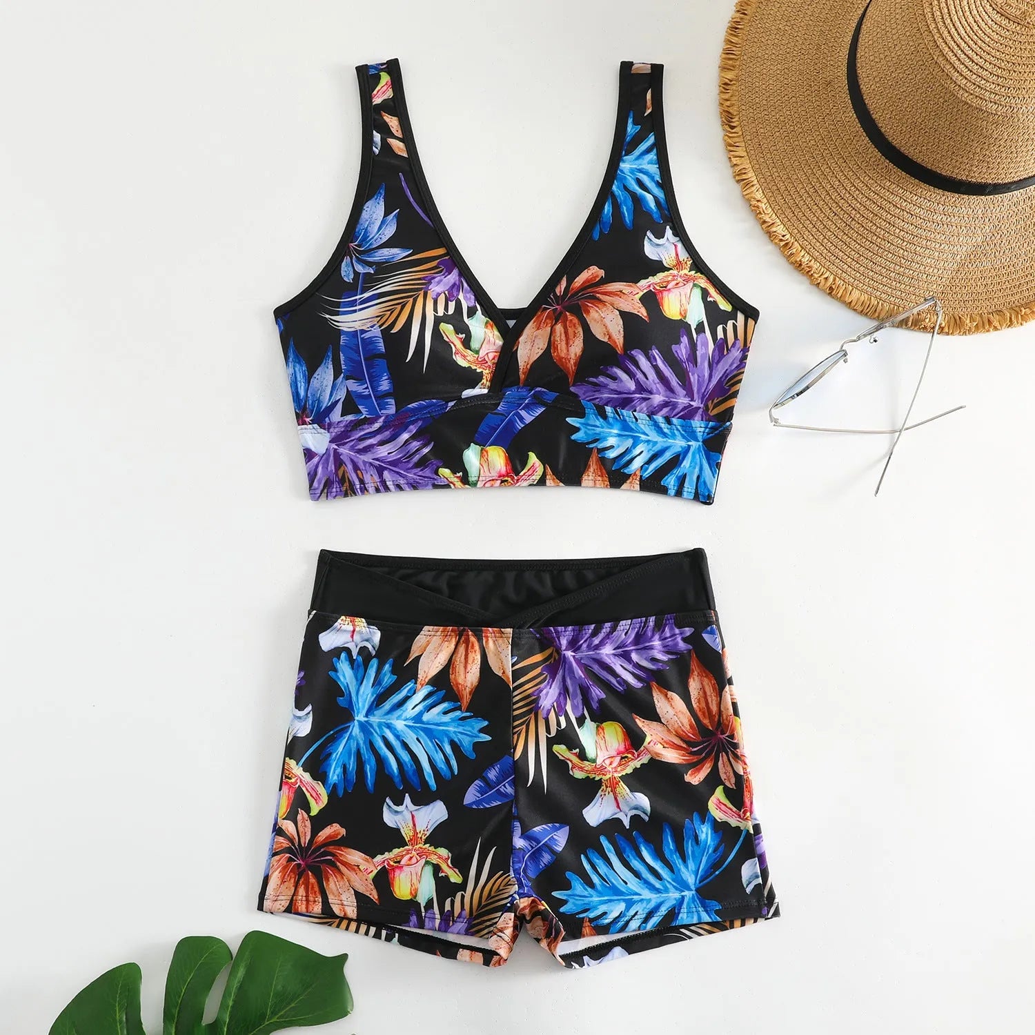 Women's two-piece swimsuit set with sleeveless top and printed boxer-style bottoms in a multi-colour pattern.