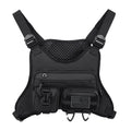 Men's black Oxford cloth chest bag worn as a vest, showing sewing line details and buckle closures.