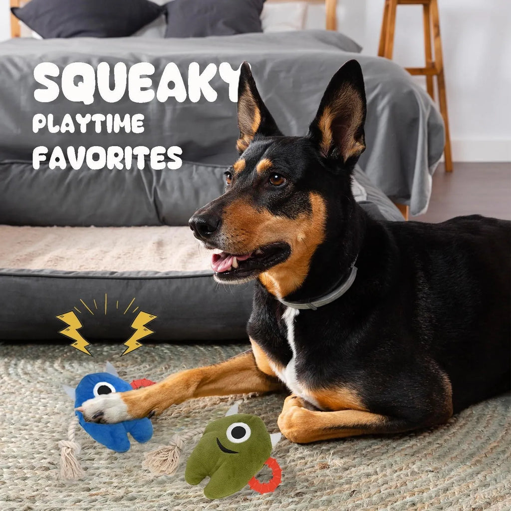 Blue or green monster plush dog toy with integrated cotton rope tug sections and a squeaker.