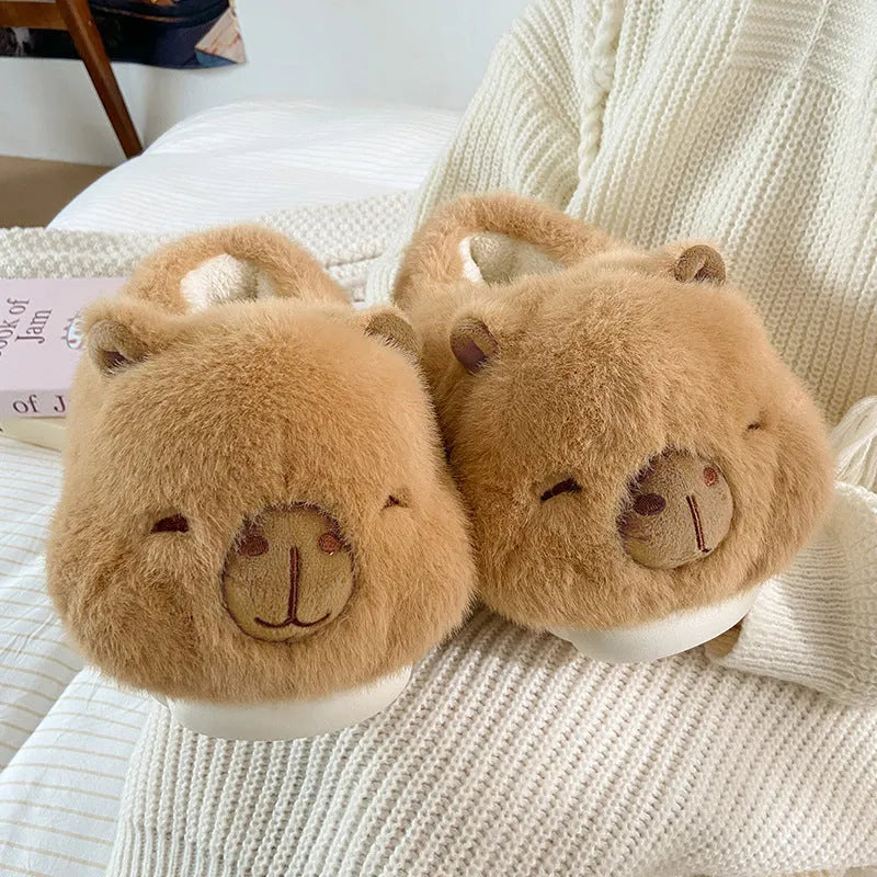 Light brown women's plush winter slippers with cartoon pattern and oversleeve design.