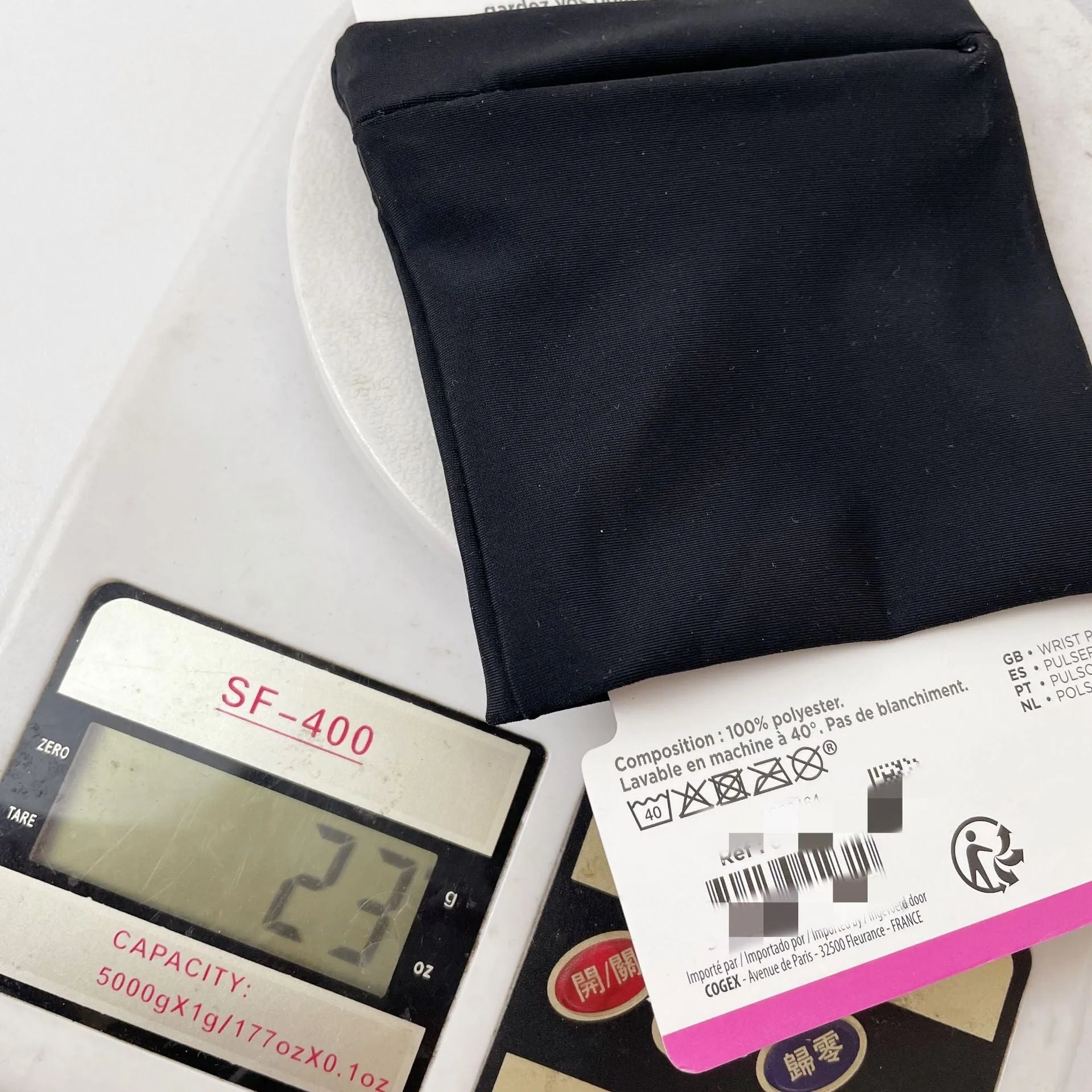 Wrist bag armband sleeve for mobile phone, shown in packaging, dimensions 10 by 10.5 cm.