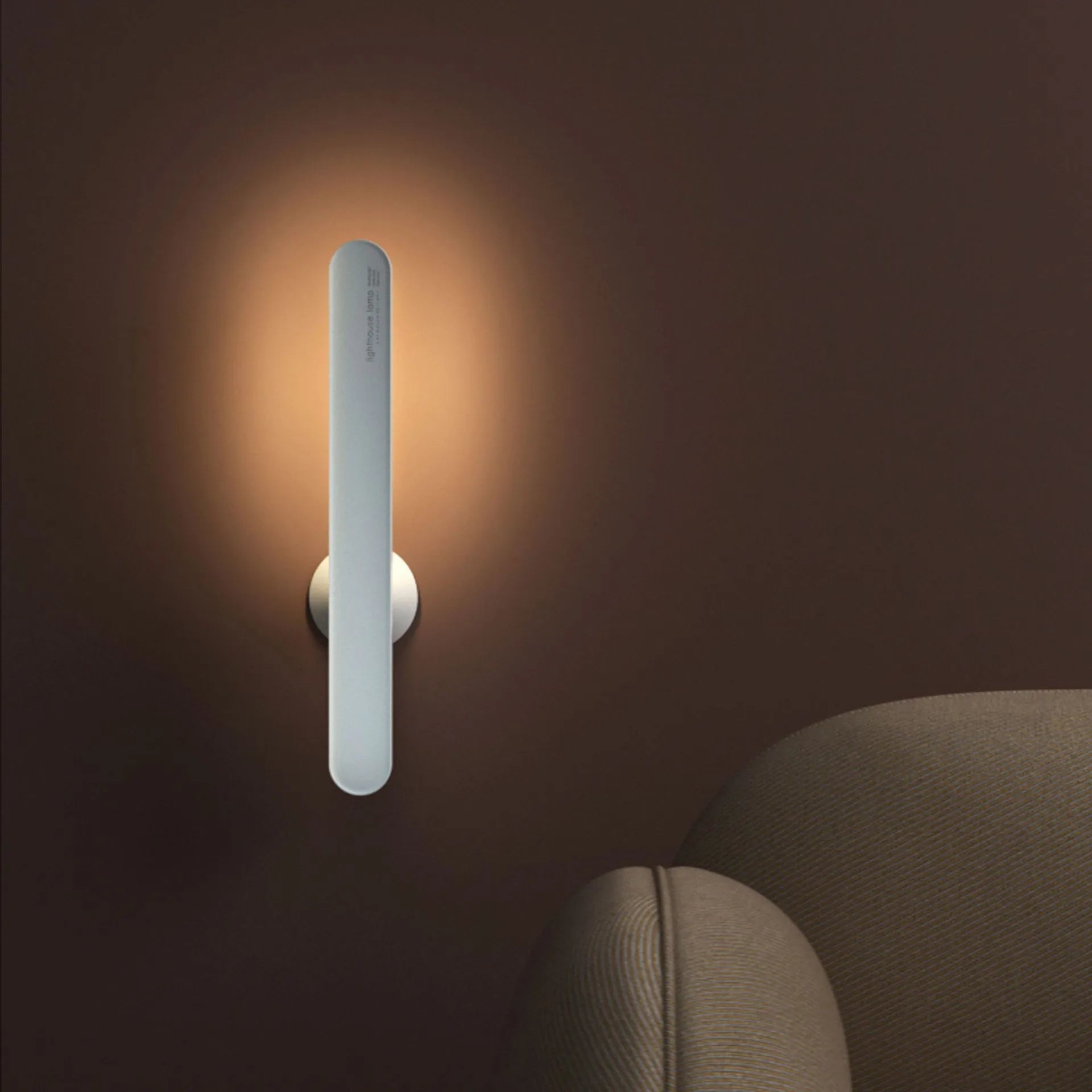White geometric USB desk lamp with magnetic base shown on a wooden desk.