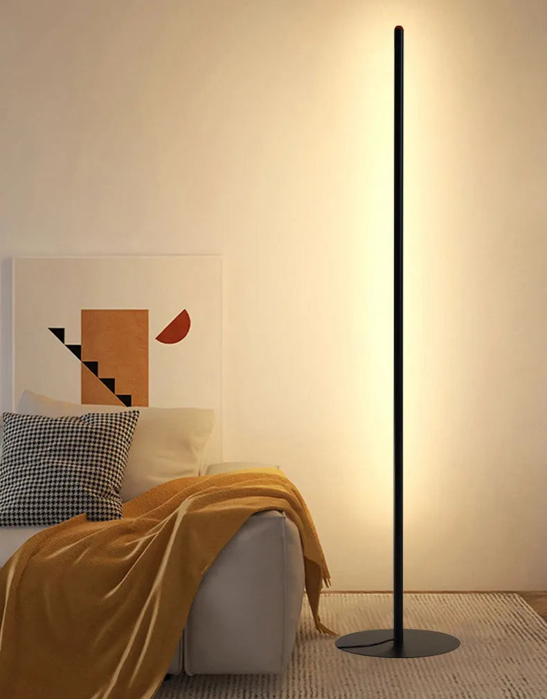 Vertical aluminium alloy floor lamp in modern simple style next to a sofa.