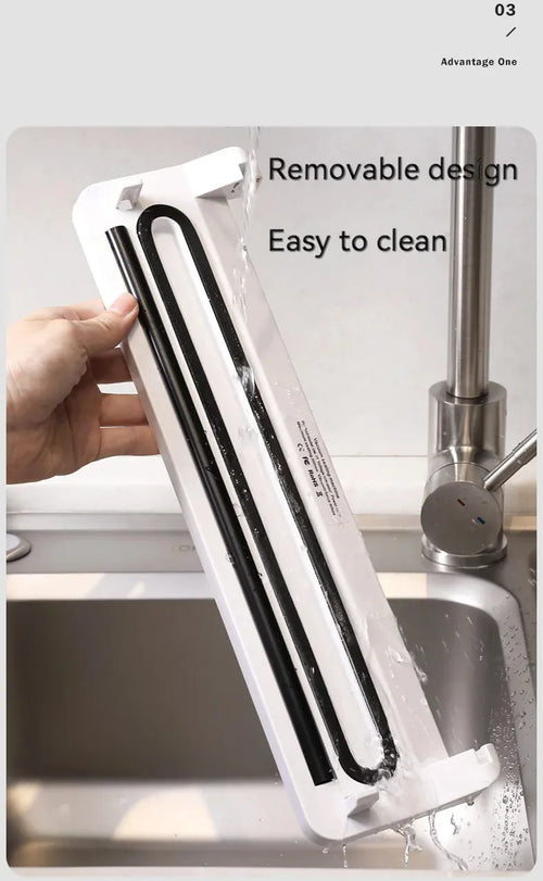 Small black automatic vacuum sealer machine on a kitchen countertop