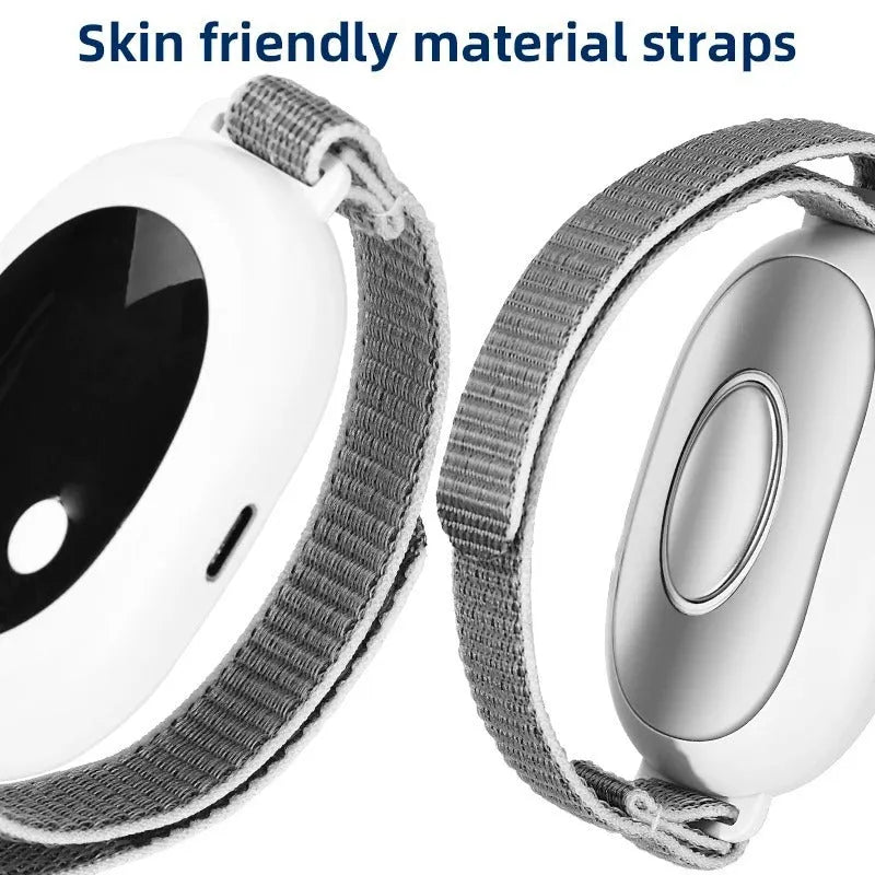White handheld sleep aid device with remote control and wearable bracelet on charging cable